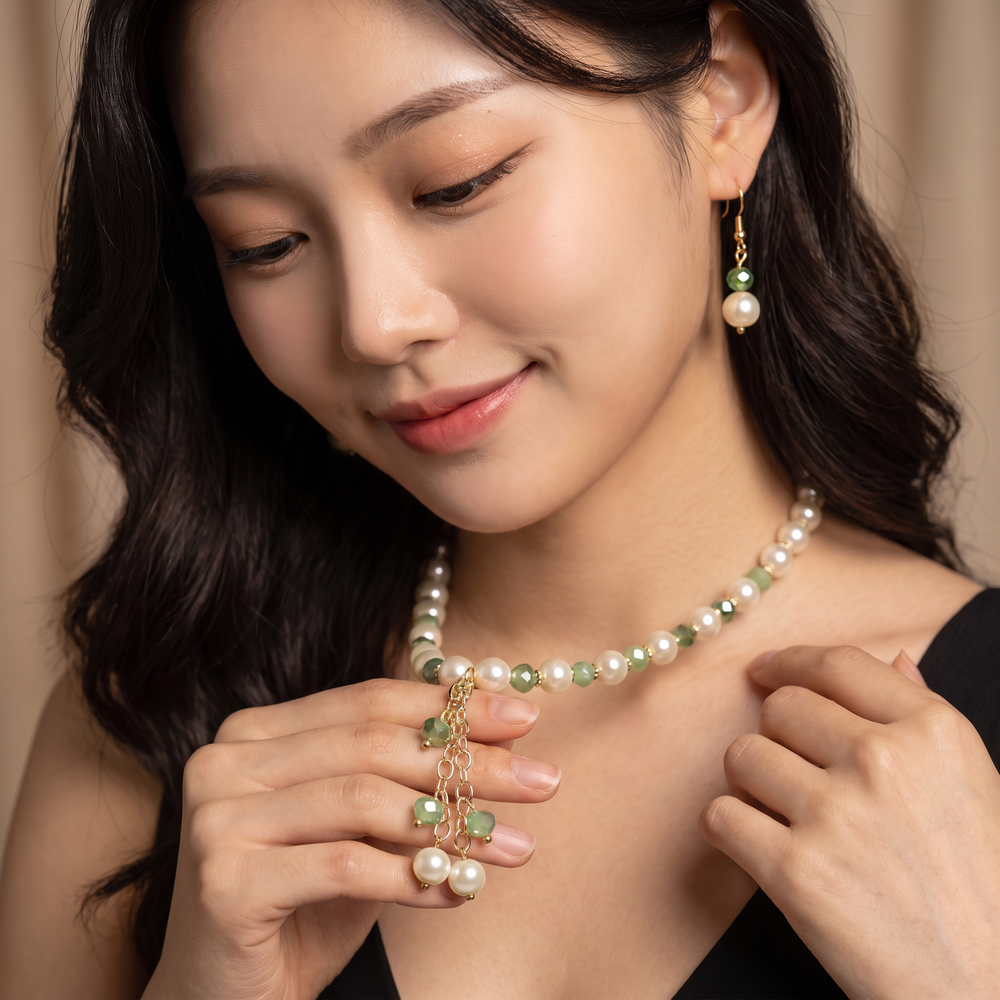 Delemon sage green crystal and cream pearl Y-drop necklace with matching drop earrings on display mannequin.