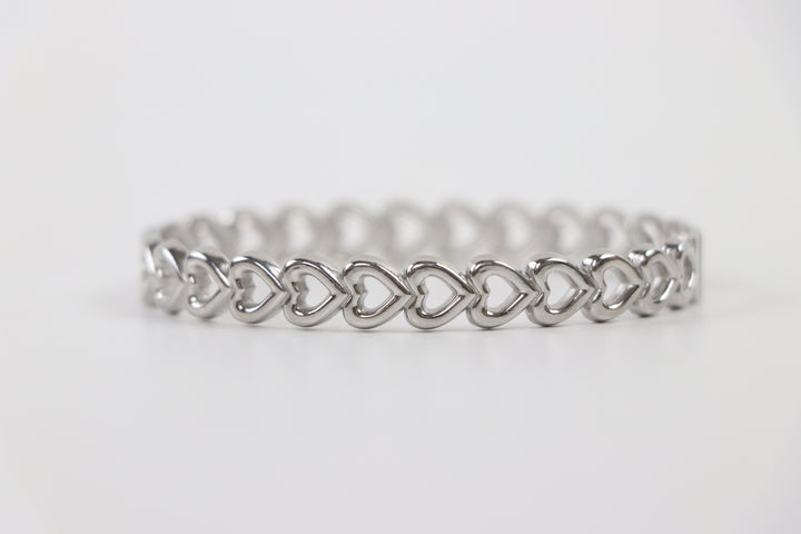 Delemon silver Amara open heart rigid bangle bracelet with continuous interlocking heart shape charms in waterproof 316L stainless steel