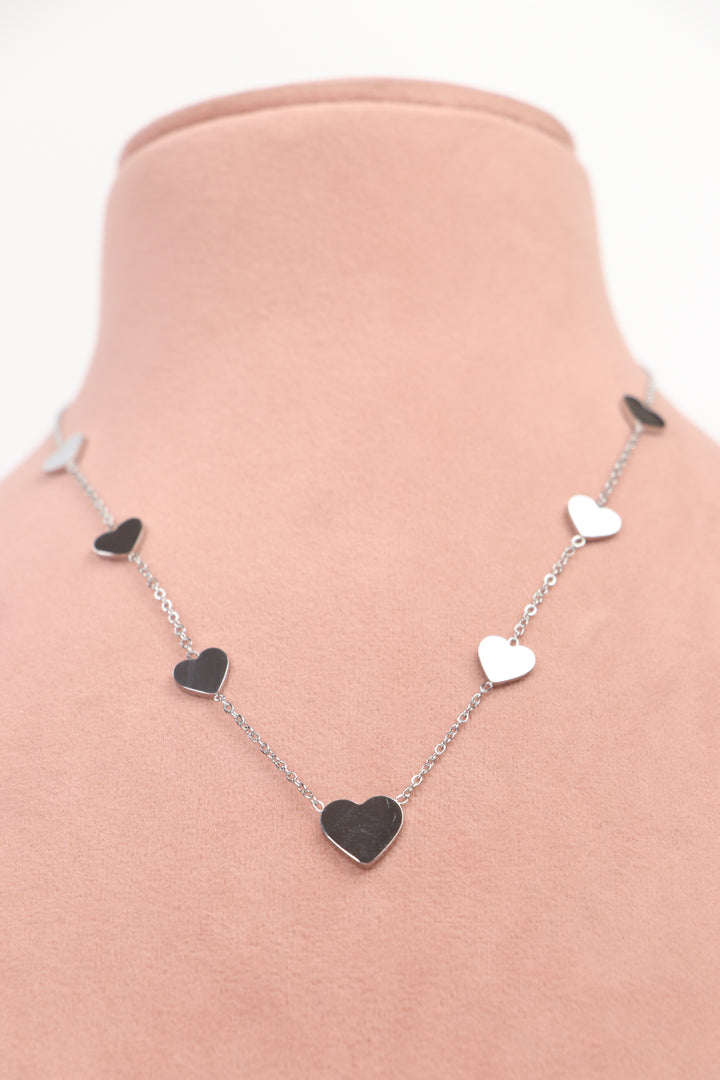 Delemon high-quality silver polished chain necklace featuring multiple delicate heart charms in a station design front view.