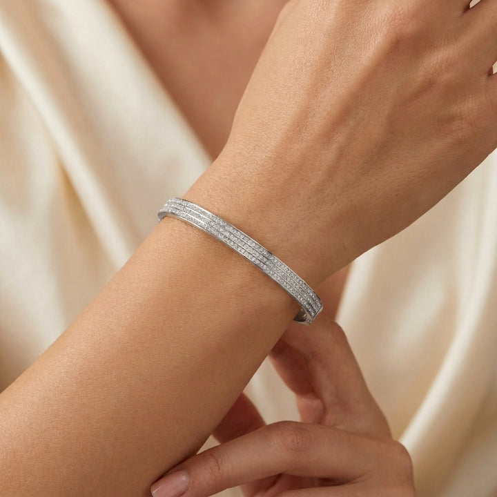 Delemon silver rigid bangle bracelet featuring three rows of clear pavé crystals in waterproof 316L stainless steel