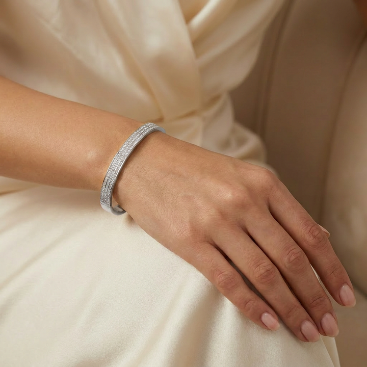 Delemon silver rigid bangle bracelet featuring three rows of clear pavé crystals in waterproof 316L stainless steel