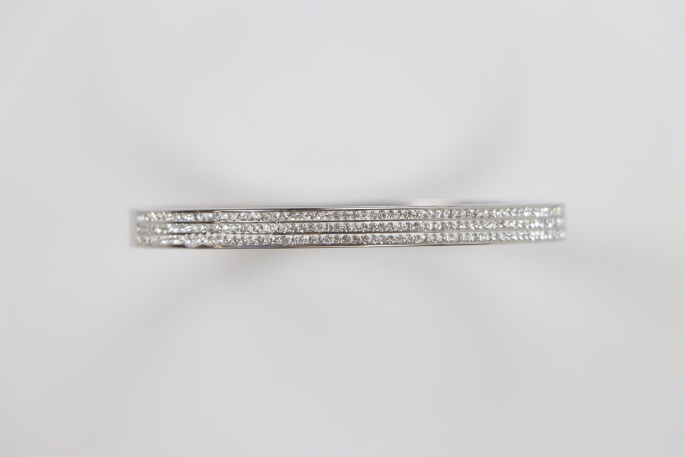 Delemon silver rigid bangle bracelet featuring three rows of clear pavé crystals in waterproof 316L stainless steel
