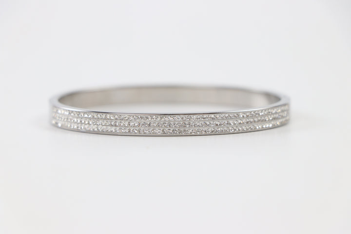 Delemon silver rigid bangle bracelet featuring three rows of clear pavé crystals in waterproof 316L stainless steel