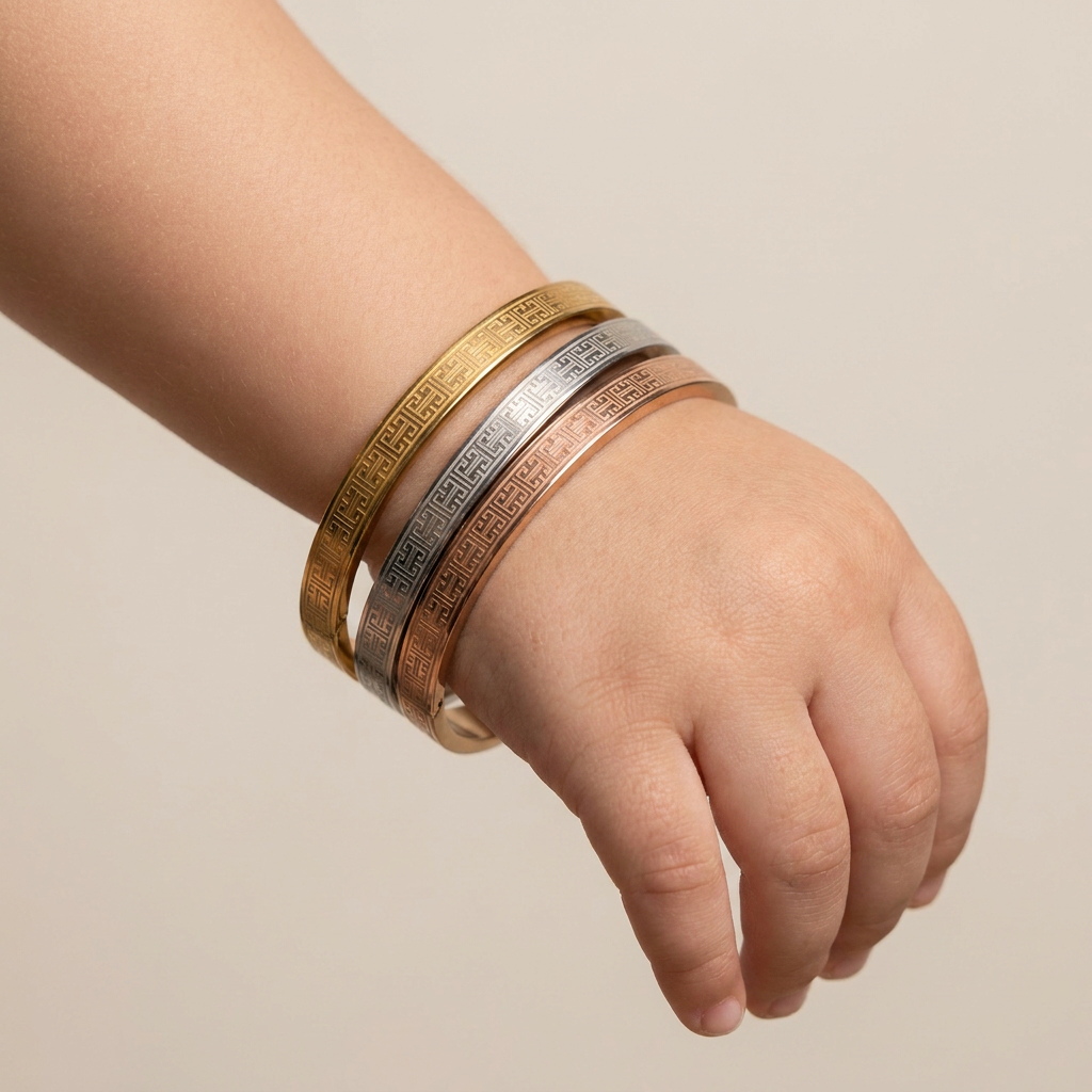 Delemon three-piece rigid bangle stack featuring yellow gold, rose gold, and silver Greek key engraved geometric bracelets in waterproof 316L stainless steel