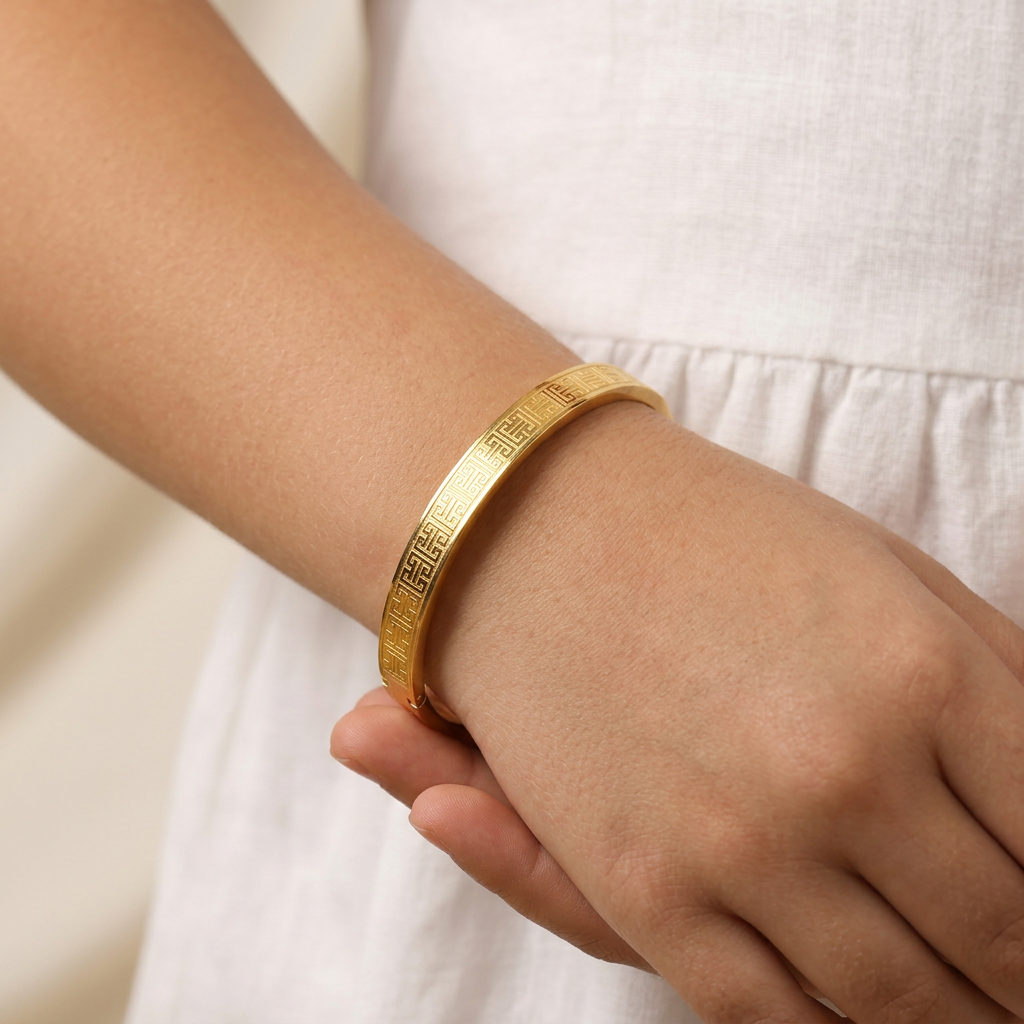 Delemon three-piece rigid bangle stack featuring yellow gold, rose gold, and silver Greek key engraved geometric bracelets in waterproof 316L stainless steel