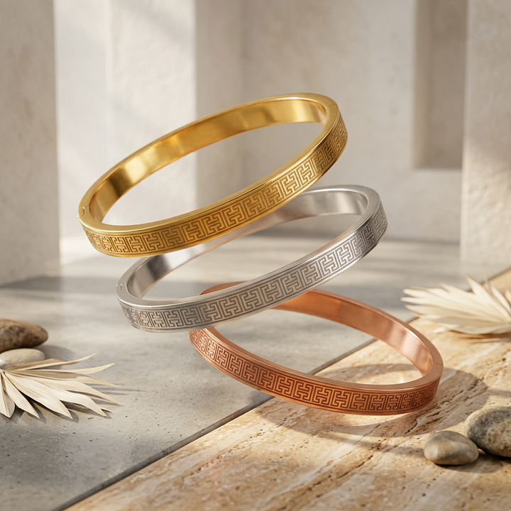 Delemon three-piece rigid bangle stack featuring yellow gold, rose gold, and silver Greek key engraved geometric bracelets in waterproof 316L stainless steel