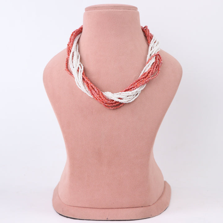 Terracotta orange-pink and white twisted multi-strand seed bead necklace on a mannequin - Delemon Collection.