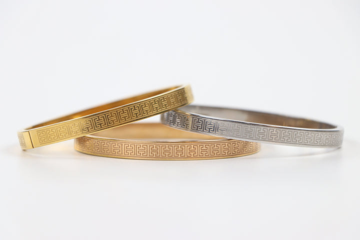 elemon three-piece rigid bangle stack featuring yellow gold, rose gold, and silver Greek key engraved geometric bracelets in waterproof 316L stainless steel