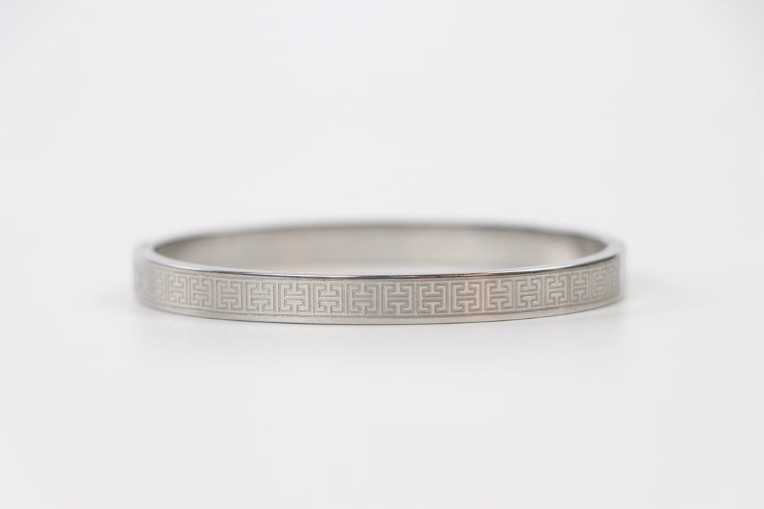 elemon three-piece rigid bangle stack featuring yellow gold, rose gold, and silver Greek key engraved geometric bracelets in waterproof 316L stainless steel