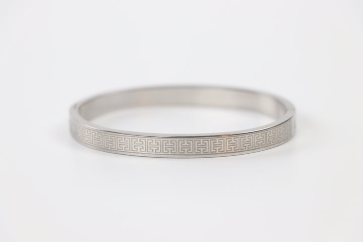 elemon three-piece rigid bangle stack featuring yellow gold, rose gold, and silver Greek key engraved geometric bracelets in waterproof 316L stainless steel