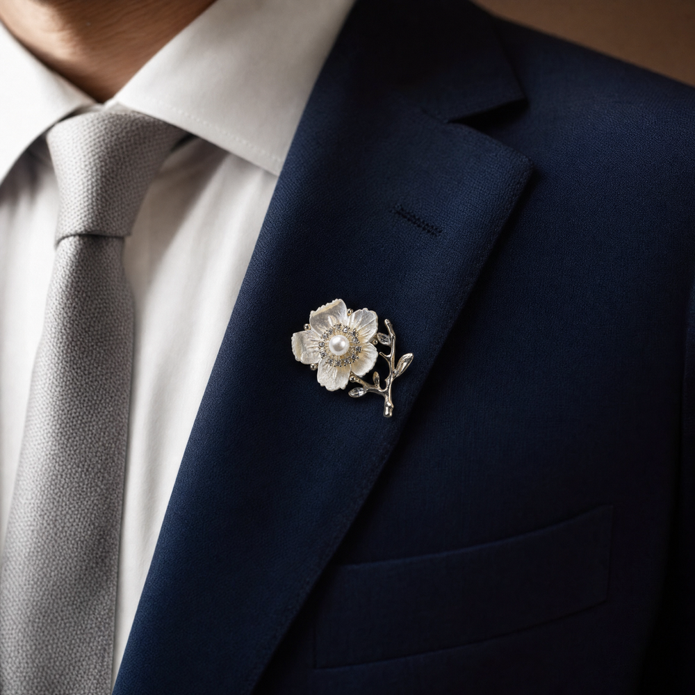 Gold-tone white enamel flower brooch pin with center pearl, rhinestone halo, and crystal branch accents