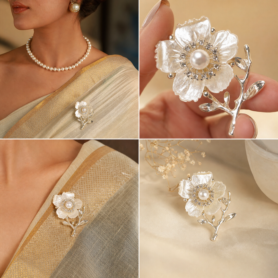 Gold-tone white enamel flower brooch pin with center pearl, rhinestone halo, and crystal branch accents