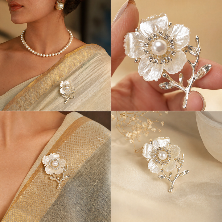 Gold-tone white enamel flower brooch pin with center pearl, rhinestone halo, and crystal branch accents
