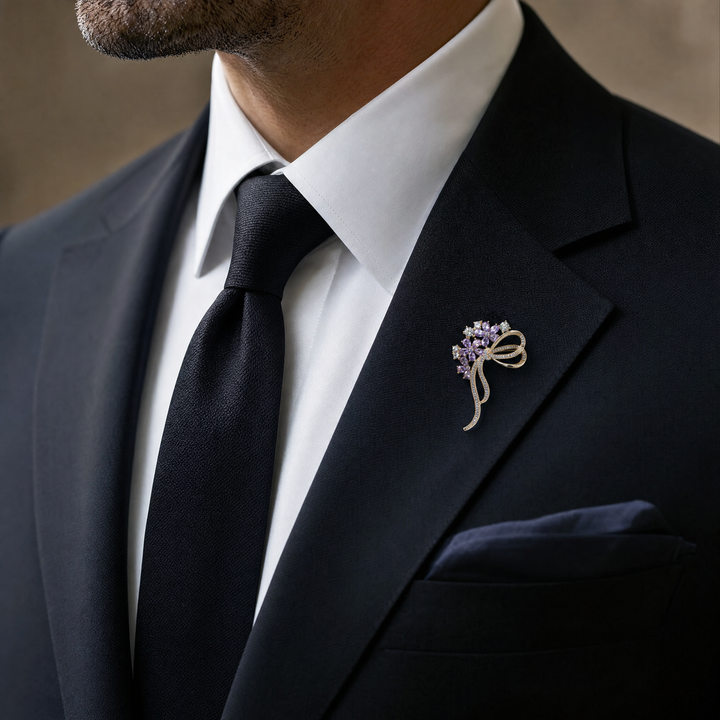 Gold-tone floral bow brooch pin featuring purple tear-drop crystal blossoms and clear pavé rhinestone ribbons 