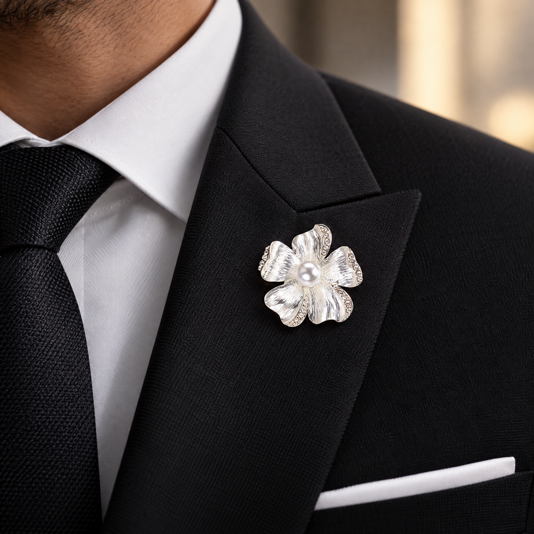 Brushed silver-tone flower brooch pin with rhinestone-trimmed petals and a large center faux pearl 