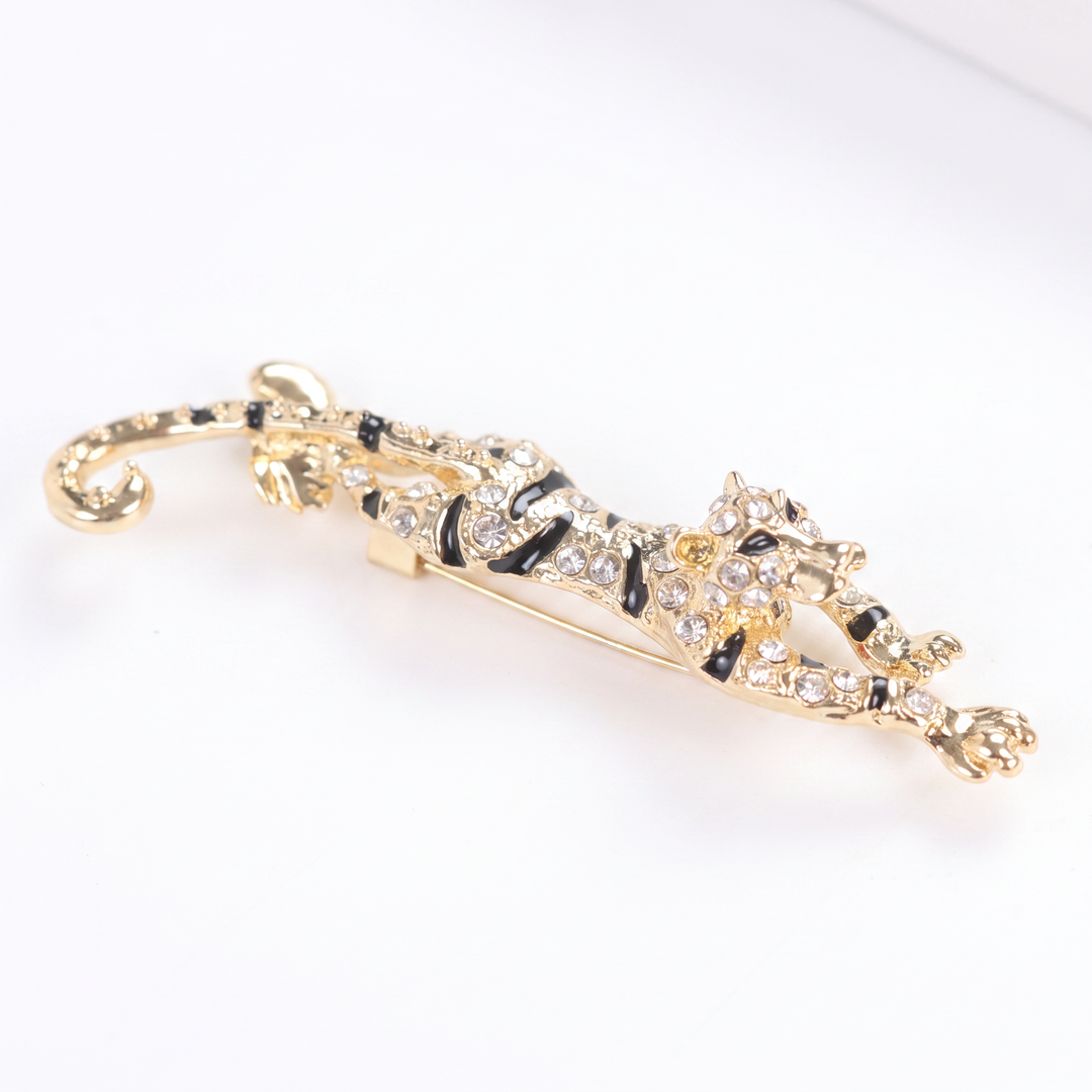 Gold prowling tiger brooch pin encrusted with clear pavé crystals and black enamel stripes 