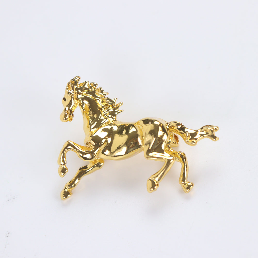 Shiny gold galloping horse brooch pin isolated against a white background by Delemon