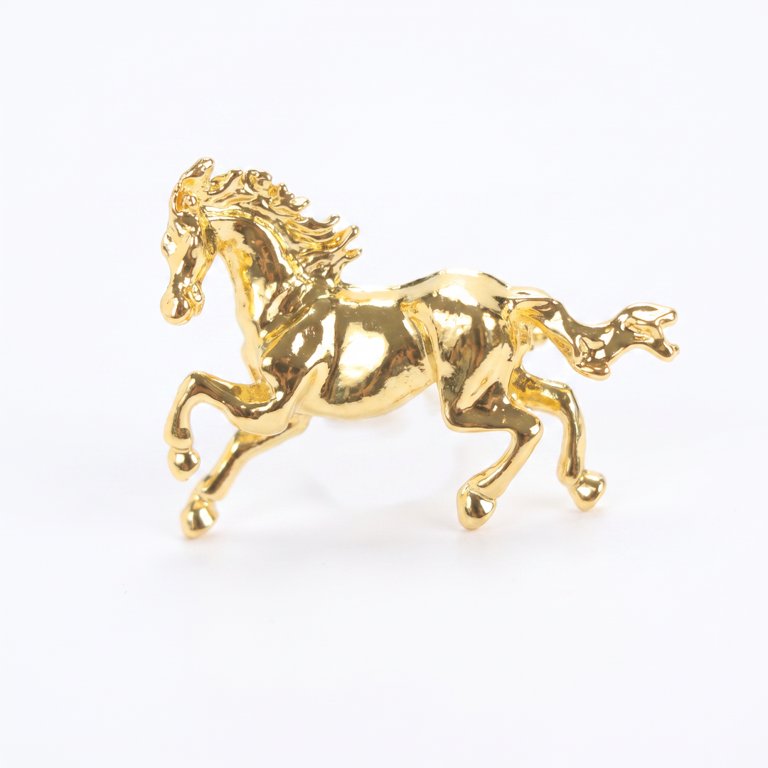 Shiny gold galloping horse brooch pin isolated against a white background by Delemon