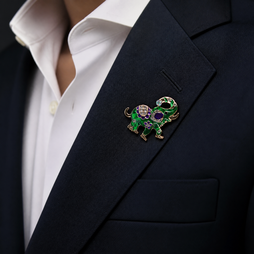 Vibrant green enamel elephant brooch pin with purple floral details and sparkling crystal accents on a white background by Delemon