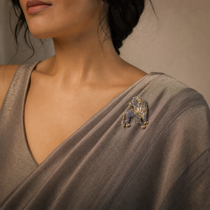 Gold-tone lion brooch pin pavé-set with sparkling periwinkle and sapphire blue crystals 
