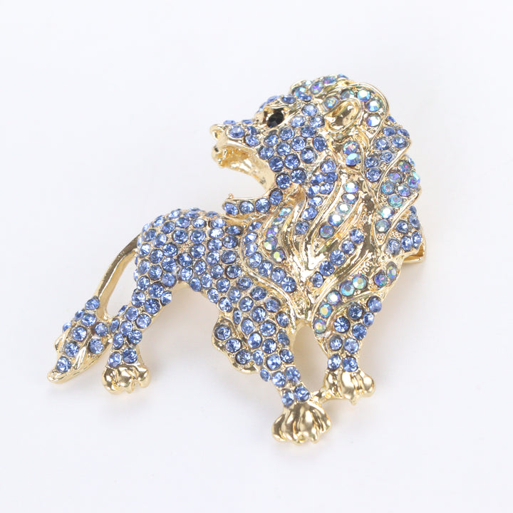 Gold-tone lion brooch pin pavé-set with sparkling periwinkle and sapphire blue crystals on a white background by Delemon