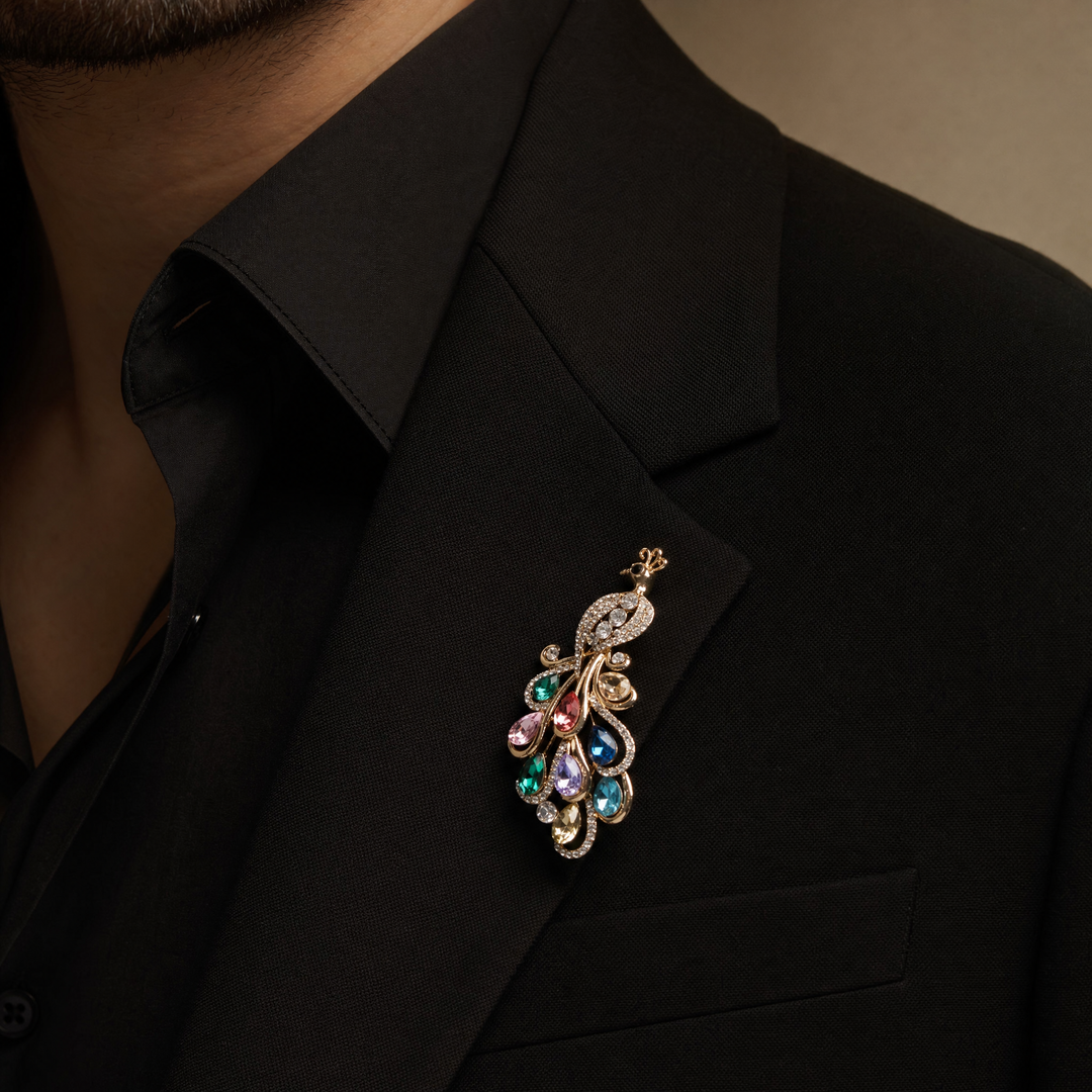 Sparkling gold peacock brooch pin adorned with colorful teardrop-cut crystals and clear pavé rhinestones