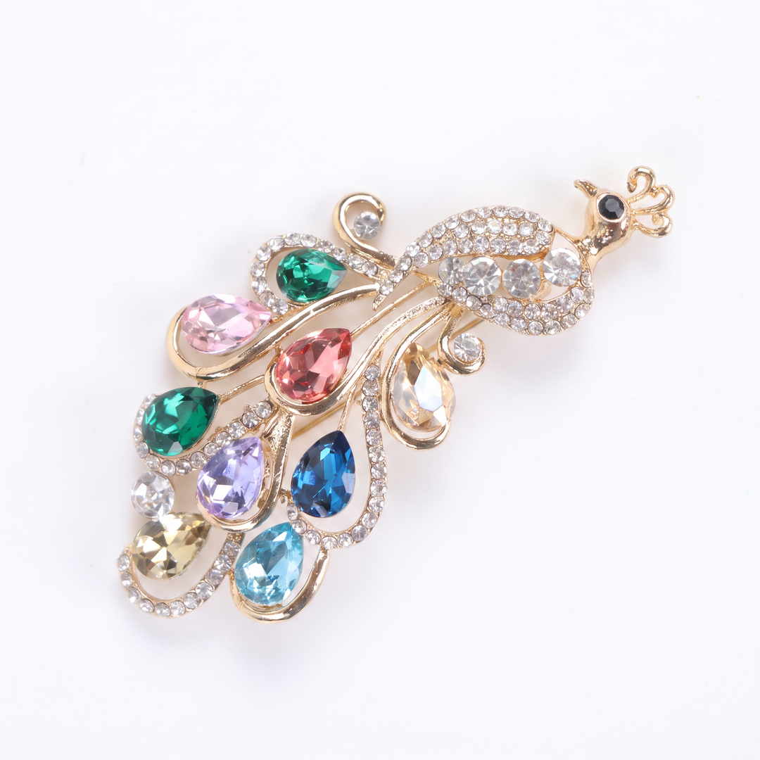 Sparkling gold peacock brooch pin adorned with colorful teardrop-cut crystals and clear pavé rhinestones
