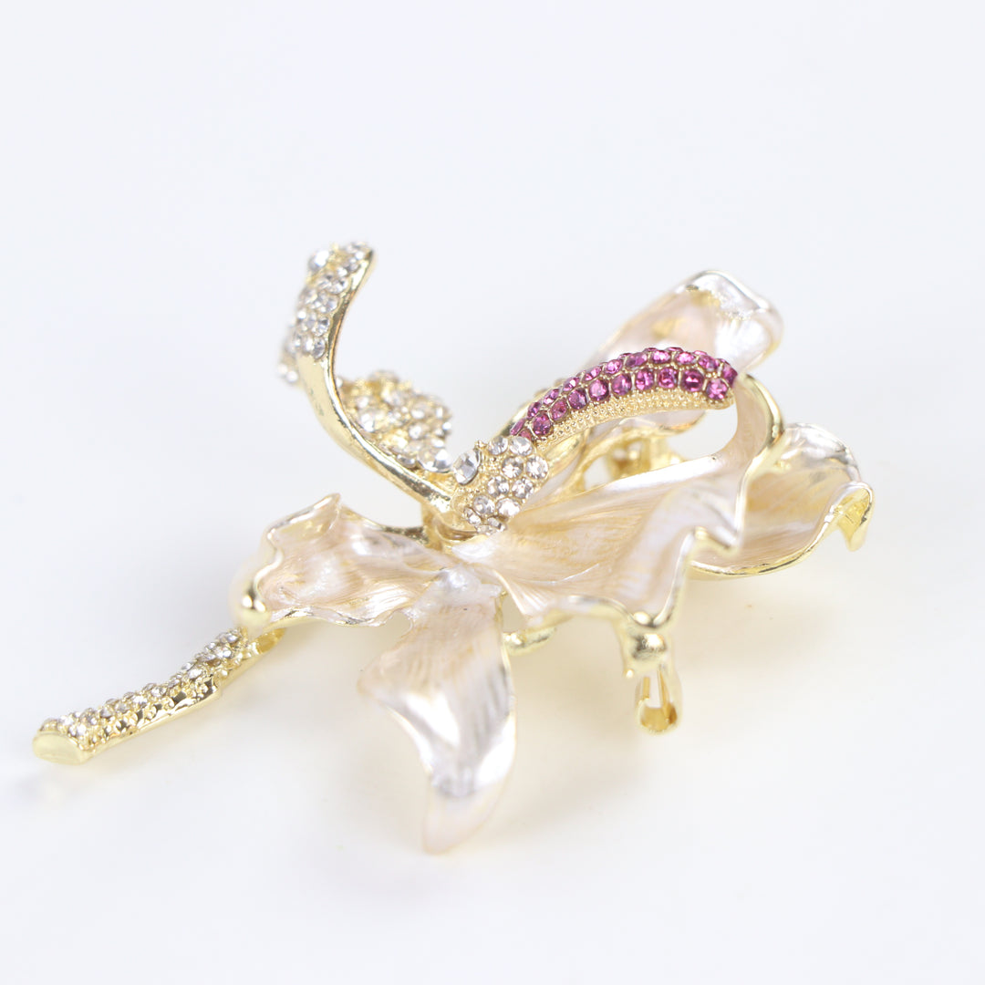 Pearlescent cream enamel flower brooch pin with pink and clear crystal accents against a white background by Delemon