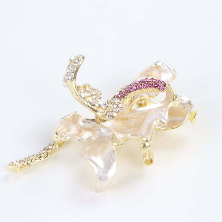 Pearlescent cream enamel flower brooch pin with pink and clear crystal accents against a white background by Delemon