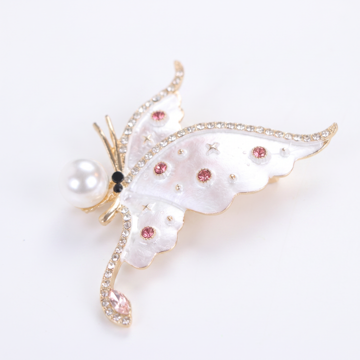 Pearlescent white enamel butterfly brooch pin with a large pearl accent and pink crystals