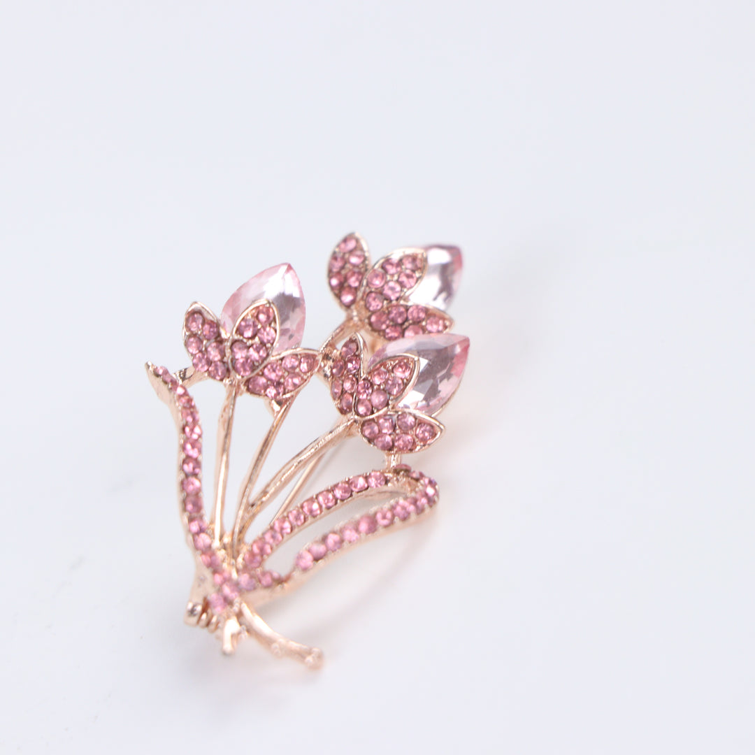 Rose gold-tone tulip bouquet brooch pin featuring faceted pink crystal gems and pink pave rhinestones on a white background by Delemon