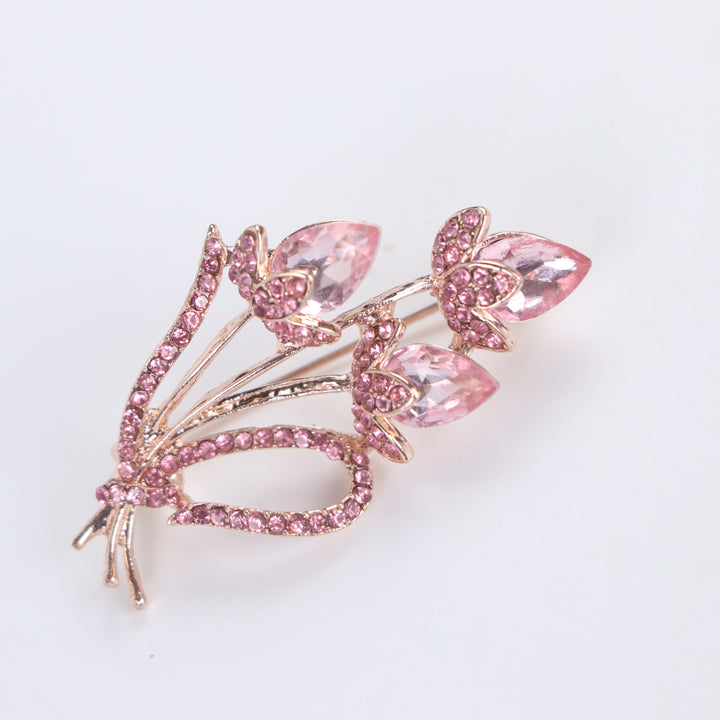 Rose gold-tone tulip bouquet brooch pin featuring faceted pink crystal gems and pink pave rhinestones on a white background by Delemon