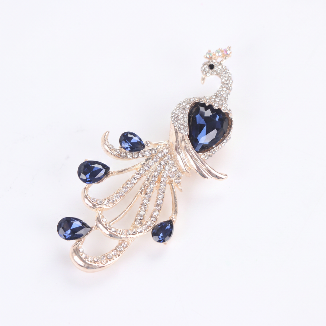 Majestic peacock brooch pin with clear pavé crystals and deep blue teardrop gems
