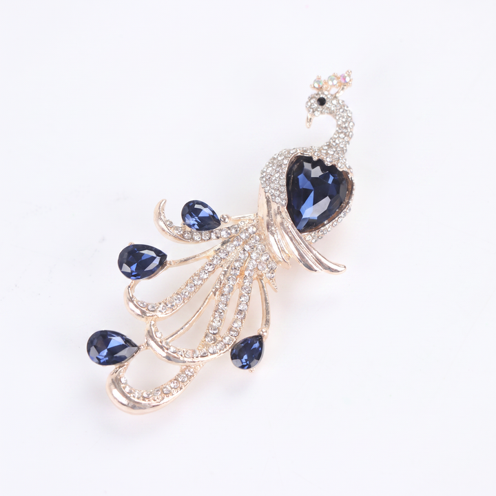 Majestic peacock brooch pin with clear pavé crystals and deep blue teardrop gems