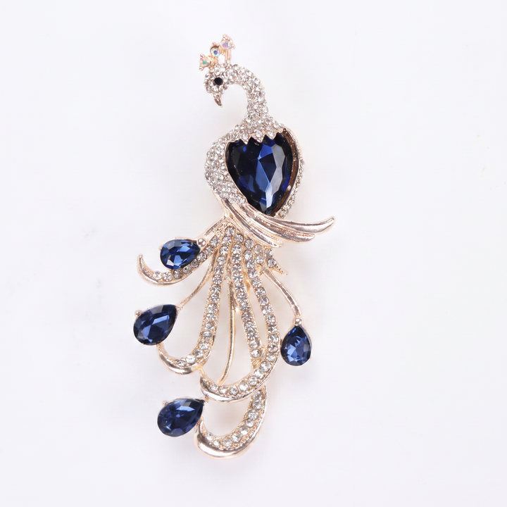 Majestic peacock brooch pin with clear pavé crystals and deep blue teardrop gems