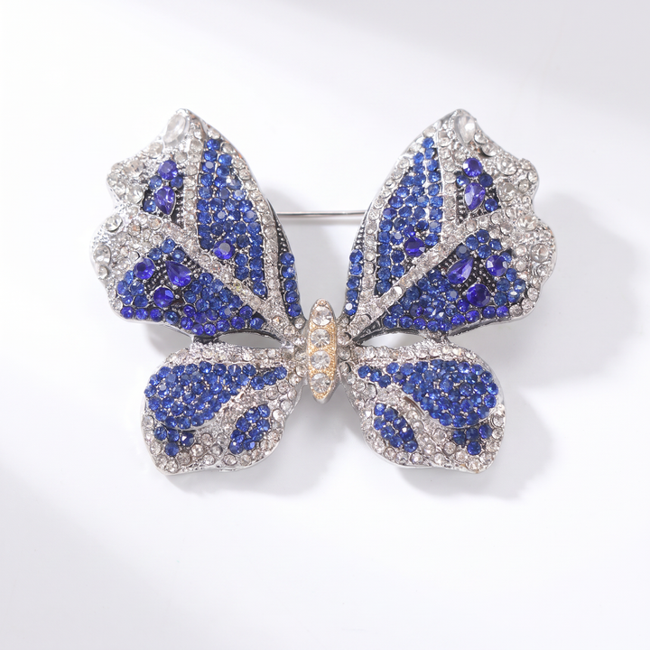 Sparkling silver-tone butterfly brooch pin encrusted with sapphire blue and clear crystals 