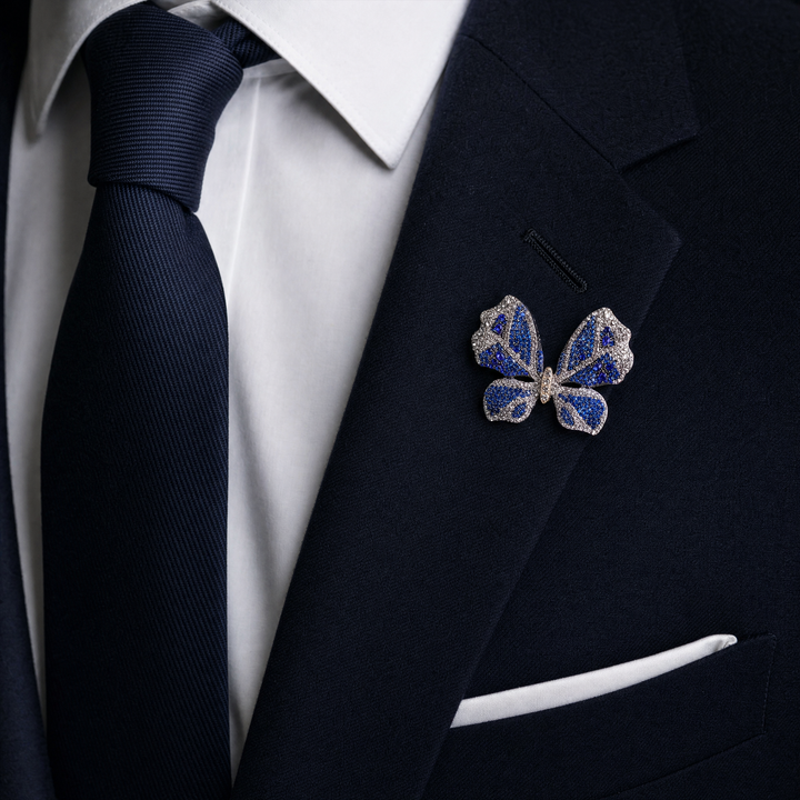 Sparkling silver-tone butterfly brooch pin encrusted with sapphire blue and clear crystals 