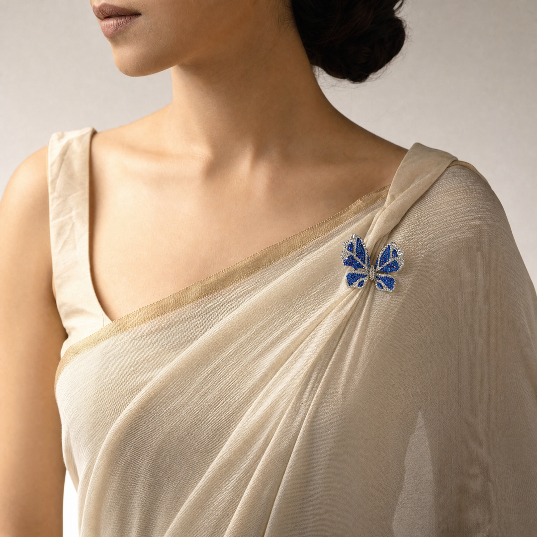 Sparkling silver-tone butterfly brooch pin encrusted with sapphire blue and clear crystals 