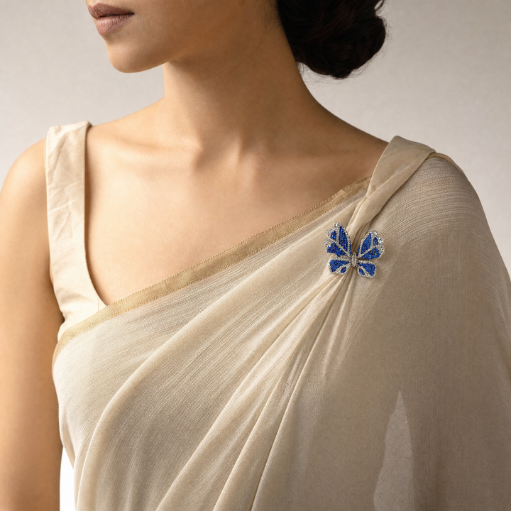 Sparkling silver-tone butterfly brooch pin encrusted with sapphire blue and clear crystals 