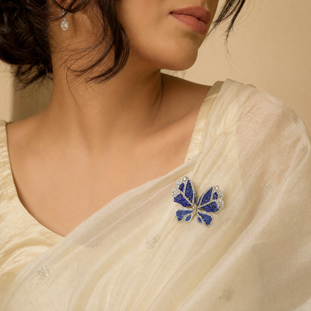 Sparkling silver-tone butterfly brooch pin encrusted with sapphire blue and clear crystals 