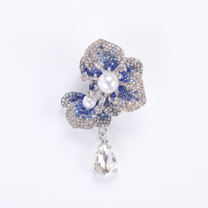 Silver-tone sapphire blue crystal orchid flower brooch pin with pearl centers and a dangling teardrop crystal 