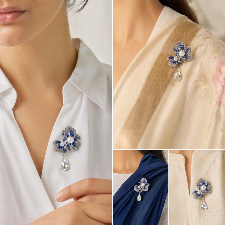 Silver-tone sapphire blue crystal orchid flower brooch pin with pearl centers and a dangling teardrop crystal 