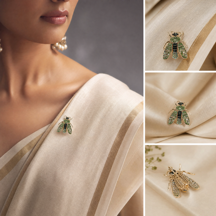 Gold-tone honeybee brooch pin encrusted with peridot and emerald green crystals on a white background by Delemon