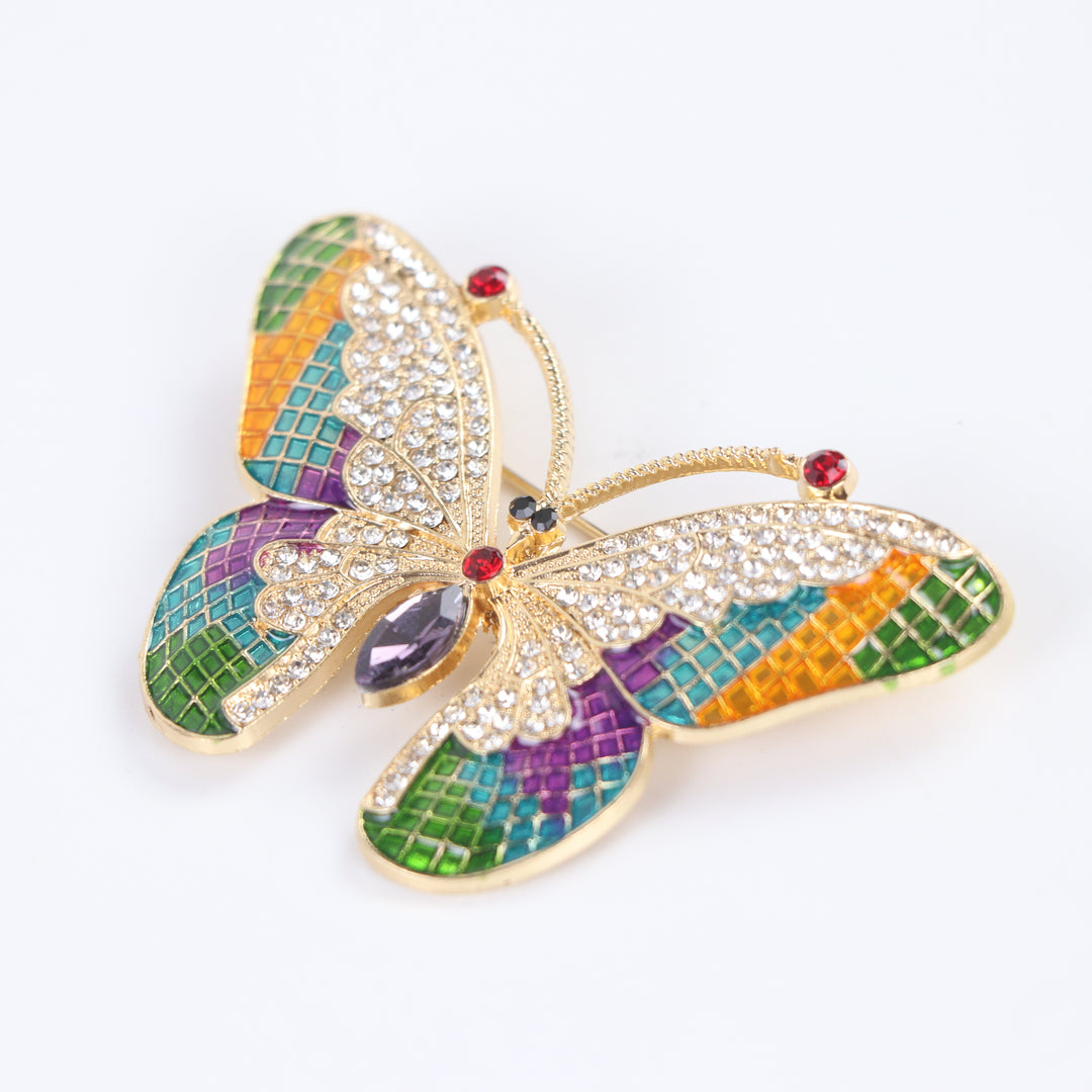 Colorful stained-glass style butterfly brooch pin with clear crystals and a purple marquise center stone against a white background by Delemon