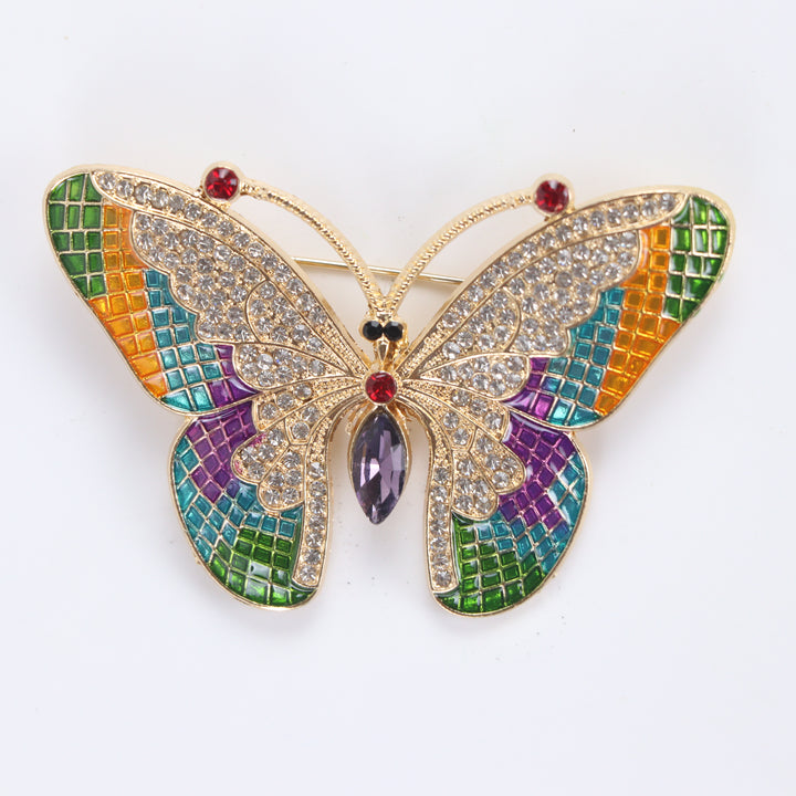Colorful stained-glass style butterfly brooch pin with clear crystals and a purple marquise center stone against a white background by Delemon