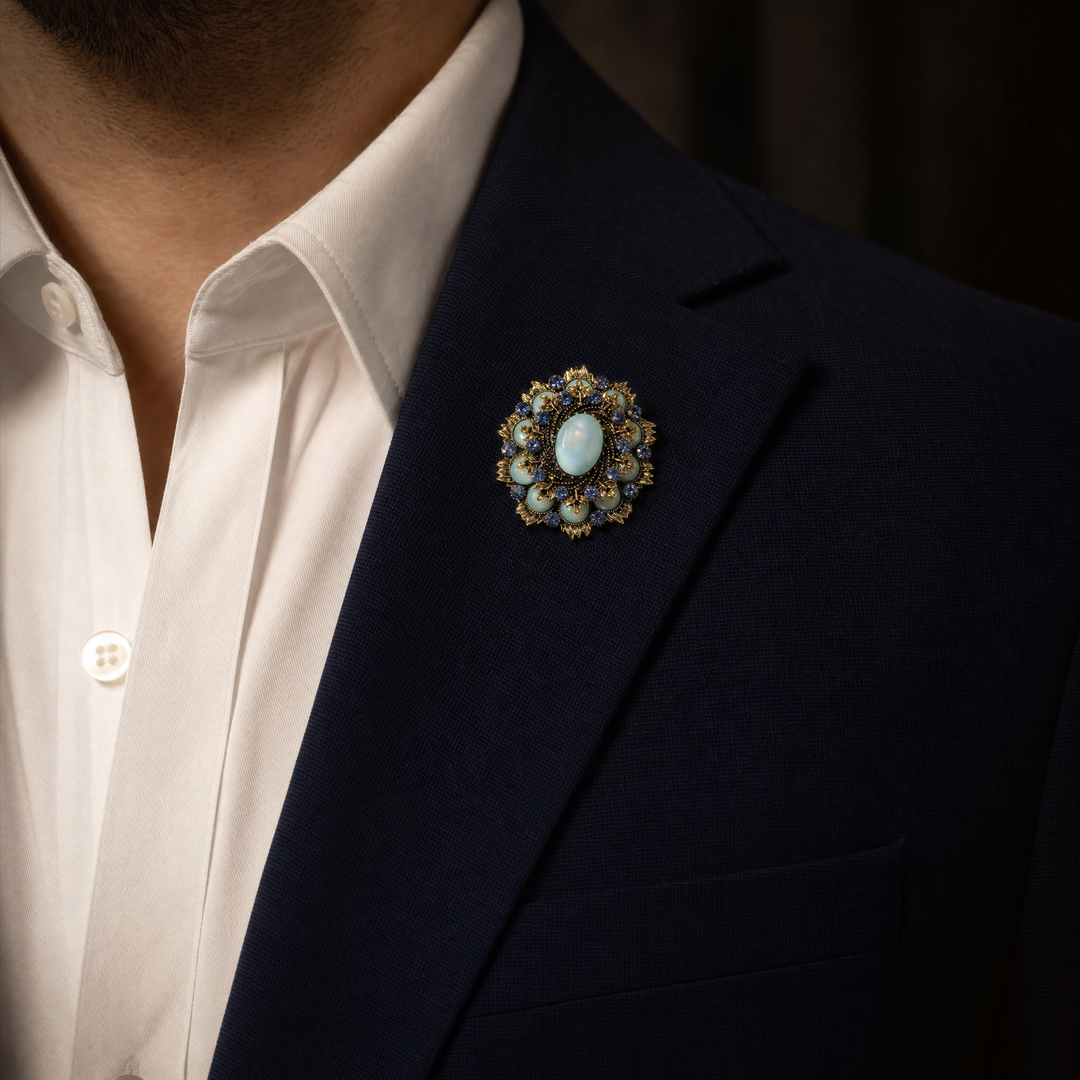 Ornate antique gold-tone round medallion brooch pin featuring a mint green cabochon center and sapphire blue crystal 