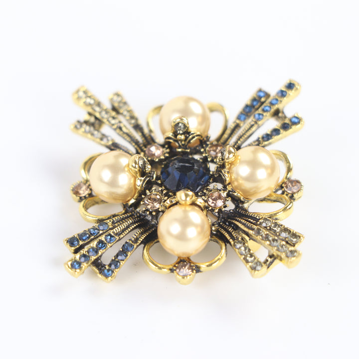 Vintage antique gold baroque cross brooch pin set with four pearl cabochons and multi-colored crystals on a white background by Delemon