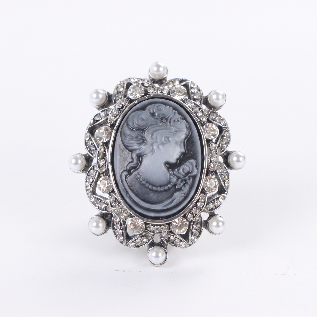 Antique silver-tone oval cameo brooch pin featuring a carved lady profile, clear rhinestones, and pearl 