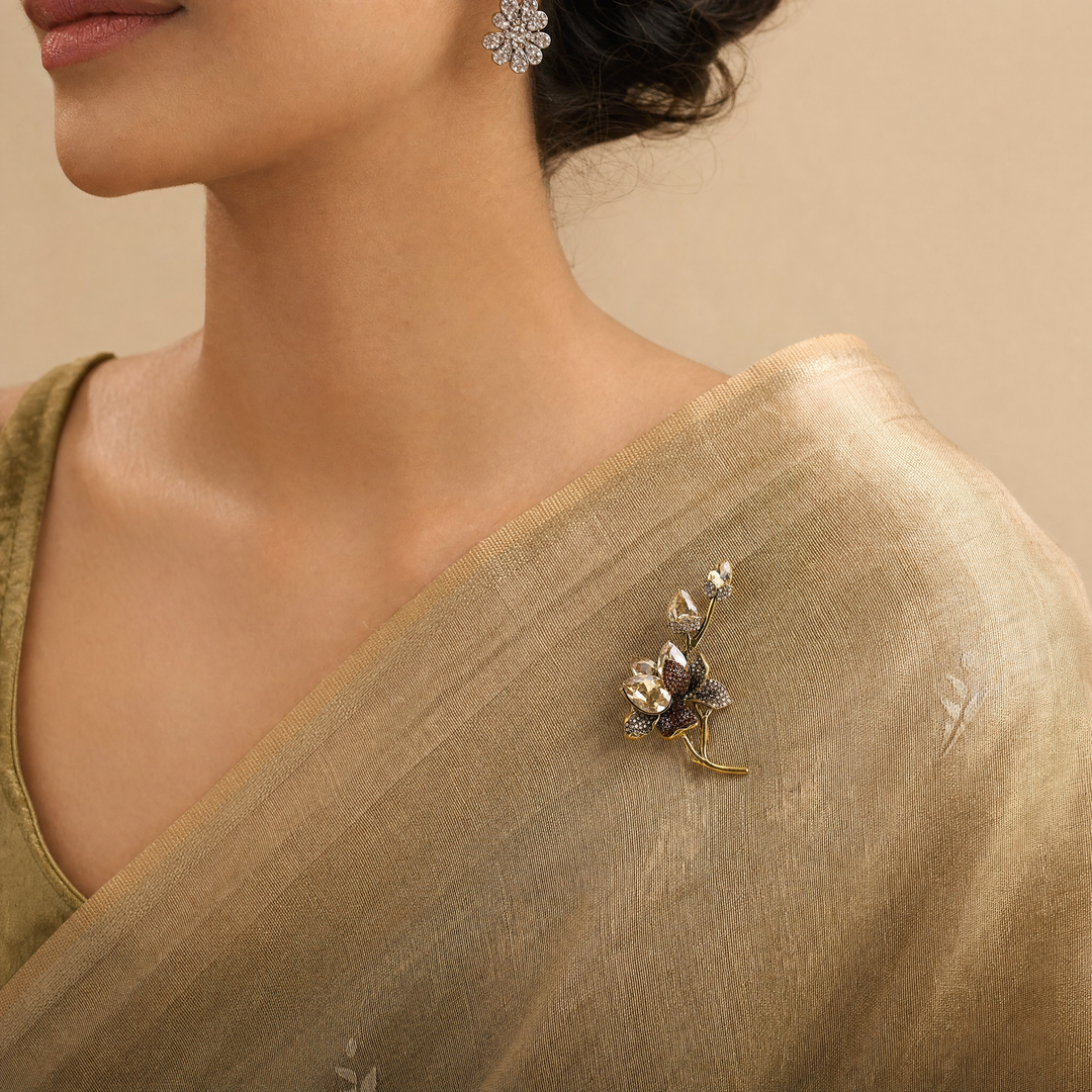 Antiqued gold-tone floral branch brooch pin featuring champagne crystals, topaz rhinestones, and crystal buds 
