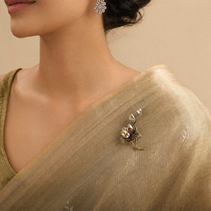 Antiqued gold-tone floral branch brooch pin featuring champagne crystals, topaz rhinestones, and crystal buds 